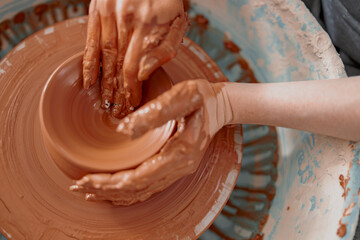 Photo of process of creating pottery by hands