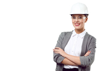 Young smiling successful female engineer with crossed arms wearing safety helmet and goggles on white isolated background