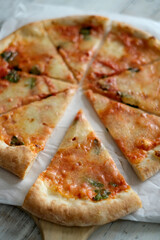 Fresh pizza with tomatoes, cheese and mushrooms on wooden table closeup
