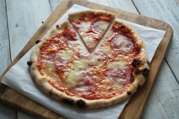Fresh pizza with tomatoes, cheese and mushrooms on wooden table closeup
