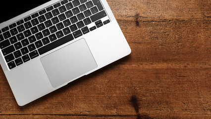 laptop keyboard on wooden rustic table top view