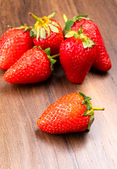 Fresh and Juicy beautiful organic strawberries on wooden background.Top view point.