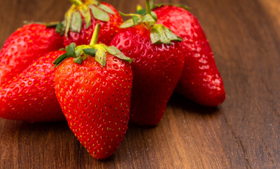 Fresh and Juicy beautiful organic strawberries on wooden background.Top view point.