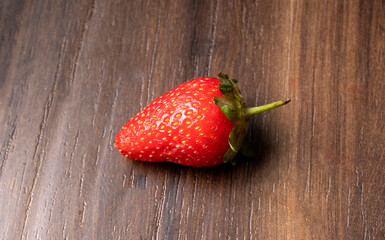 Fresh and Juicy beautiful organic strawberries on wooden background.Top view point.