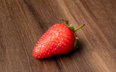Fresh and Juicy beautiful organic strawberries on wooden background.Top view point.