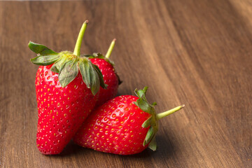 Fresh and Juicy beautiful organic strawberries on wooden background.Top view point.