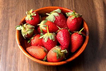 Fresh and Juicy beautiful organic strawberries on wooden background.Top view point.