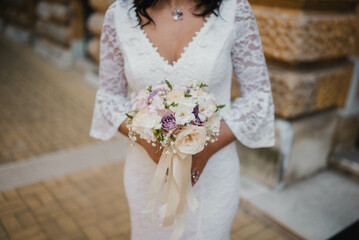 Bride holding a wedding bouquet. Rustic wedding bouquet.