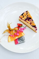 A piece of blueberry cheesecake on the table.
