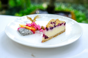 A piece of blueberry cheesecake on the table.