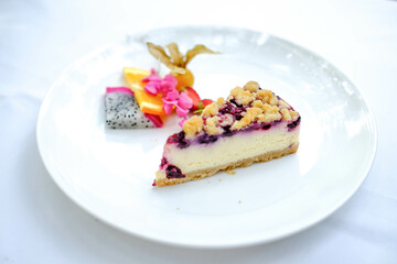 A piece of blueberry cheesecake on the table.
