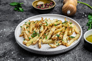 Roasted Parsnips on light Background. side dish on plate. Delicious vegetarian breakfast or snack, Clean eating, dieting, vegan food concept. banner, menu, recipe place for text, top view