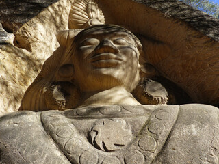 Buddha sculpture carved into the rock of a mountain