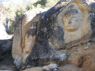 Buddha sculpture carved into the rock of a mountain