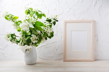 Wooden frame mockup with apple blossom in the vase