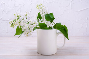 White coffee mug mockup with blooming white lilac