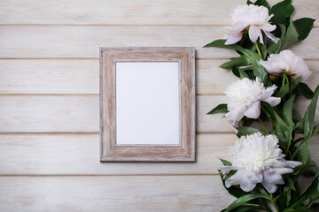 Wooden picture frame mockup with pale pink peony