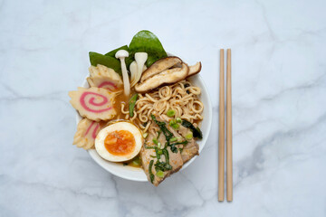 Ramen Soup bowl With chopsticks over marble table