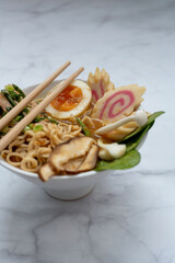 Ramen Soup bowl With chopsticks over marble table