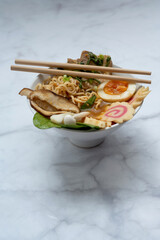 Ramen Soup bowl With chopsticks over marble table