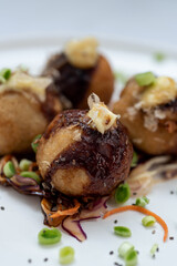 A plate of takoyaki snack