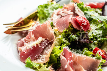 Salad with Prosciutto, ham and grapefruit jamon, salad mix, grapefruit, cherry tomatoes, parmesan cheese. Healthy food, keto diet, diet lunch concept