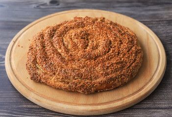 Sweet tahini roll cake, table top stock footage . Still life of delicious fresh tahini bun on round wooden table Stock Photo