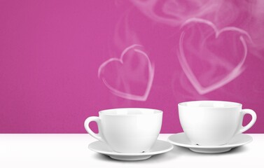 Fototapeta na wymiar Mockup white coffee with two cups or mugs on a background. Hot drink steam in the form of hearts