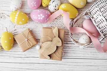 bunny, colorful easter eggs and spring flowers