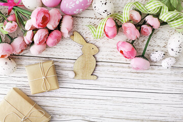 bunny, colorful easter eggs and spring flowers