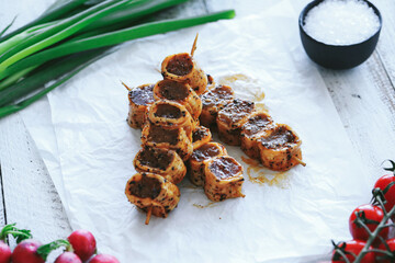 Shashlik or shish kebab prepared on barbecue grill over hot charcoal with grilled vegetables. Grilled pieces of pork meat on metal skewers.