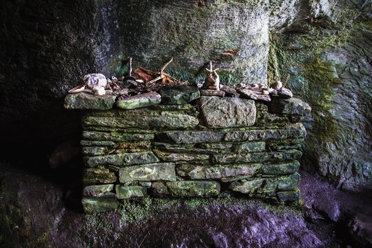 Detail of the interior and exterior of St Columba's Cave, Ellary, Argyll. Showing tribures on the altar including a St Bridgid's cross, an early Christian / pagan symbol.