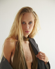 Long hair blonde model posing in studio on white background