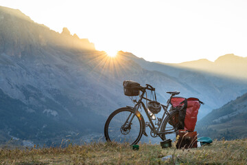 Naklejka na ściany i meble Packed Travel bicycle with a sunset