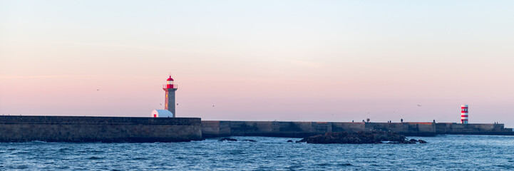 Fototapeta na wymiar Farolim de Felgueiras is 19th century hexagonal lighthouse on the Douro River, Porto, Portugal during sunrise