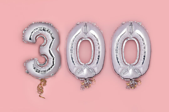 Balloon Bunting for celebration Happy 300th Anniversary made from Silver Number Balloons on pink background. Holiday Party Decoration or postcard concept with top view