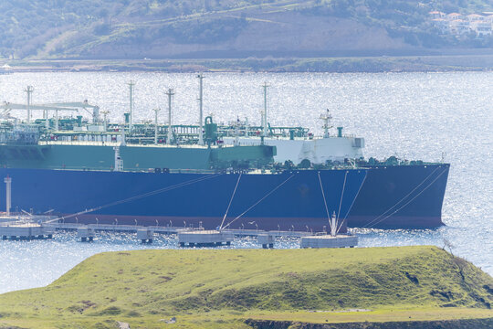 Two ships connected to the pier making LNG transfer