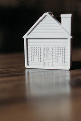 Obraz na płótnie Canvas sweet home concept, mini toy house on wooden background
