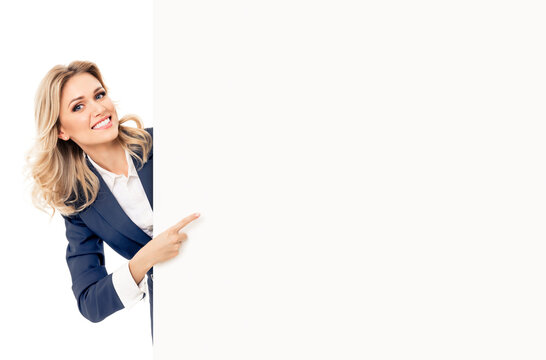 Happy Smiling Blond Young Business Woman In Blue Suit, Standing Behind, Peeping From Blank Banner Or Mock Up Signboard, Showing Copy Space, Isolated Over White Background.