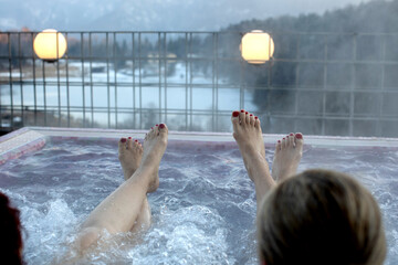 People, enjoying whirlpool and saunta after day of skiing, relaxing in nice warl whirlpool outdoor,...