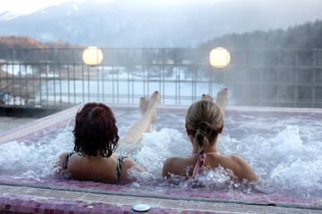 People, enjoying whirlpool and saunta after day of skiing, relaxing in nice warl whirlpool outdoor,...