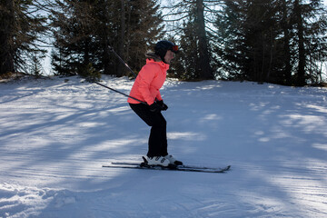 Happy family, skiing in Italy on a sunny day, kids and adults skiing together