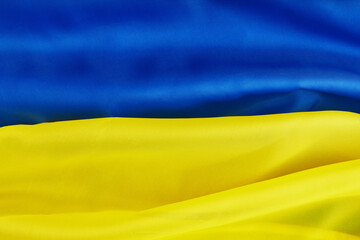 Ukrainian national flag. Blue and yellow colors fabric. Close up shot, selective focus, background, top shot