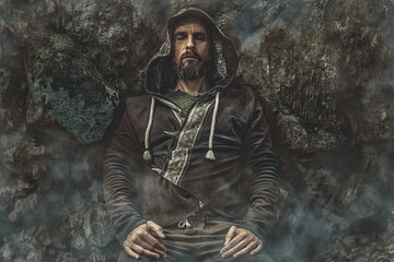 Shamanic man in ornamental dress in the nature.