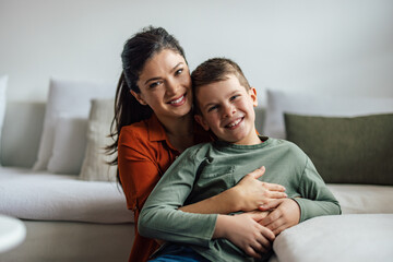 Portrait of two happy family members, mother, and son in a hug.