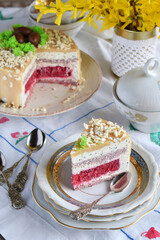 Easter cake decorated with chocolate eggs: nut biscuit, currant jelly,  cheese mousse with poppy and white chocolate glaze. Homemade baking. Gluten-free