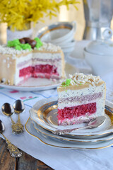 Easter cake decorated with chocolate eggs: nut biscuit, currant jelly,  cheese mousse with poppy and white chocolate glaze. Homemade baking. Gluten-free