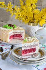Easter cake decorated with chocolate eggs: nut biscuit, currant jelly,  cheese mousse with poppy and white chocolate glaze. Homemade baking. Gluten-free