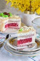 Easter cake decorated with chocolate eggs: nut biscuit, currant jelly,  cheese mousse with poppy and white chocolate glaze. Homemade baking. Gluten-free