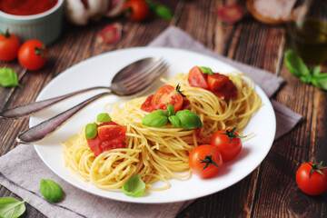Italian pasta spaghetti with basil and cherry tomatoes	